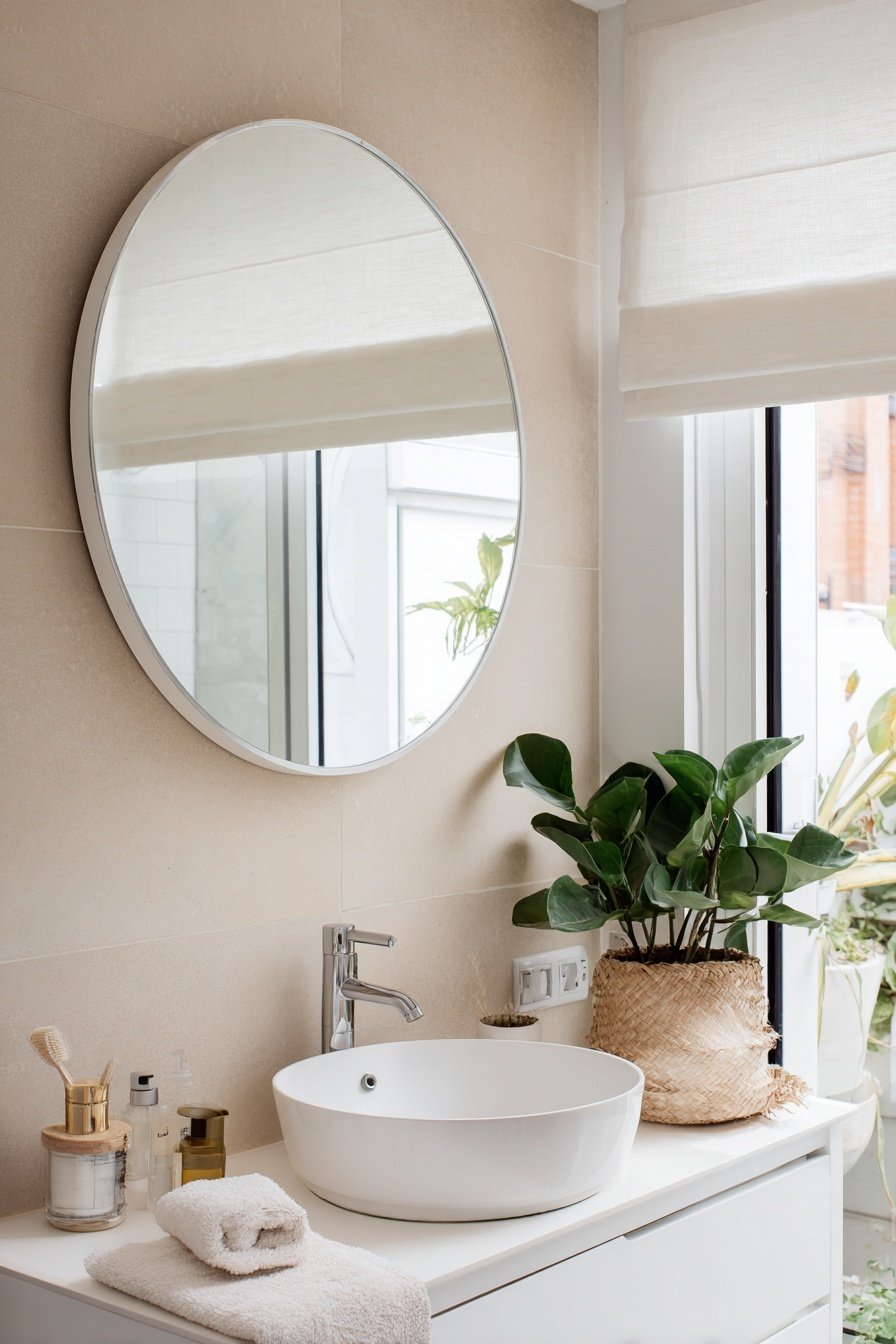 Modernes kleines Gäste-WC mit Fenster, rundem Spiegel und Pflanzen