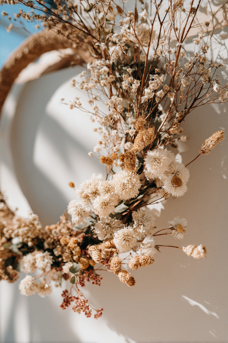 Frühlingskranz aus Trockenblumen und Ästen an Haustür